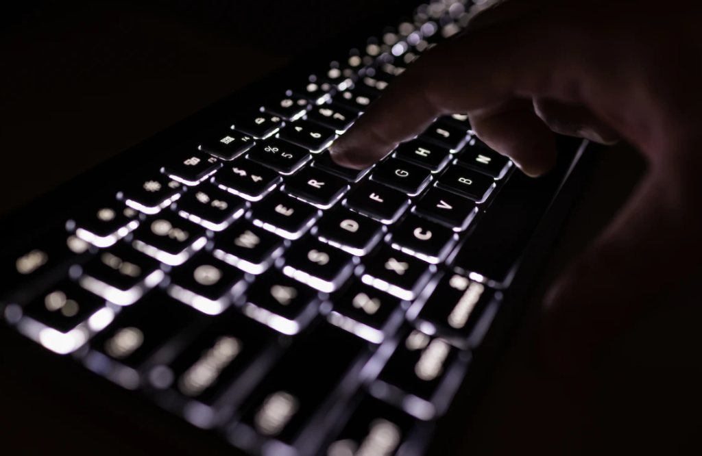 Is AI Listening in on Your Keystrokes? black keyboard with lit up keys to illustrate ai listening study